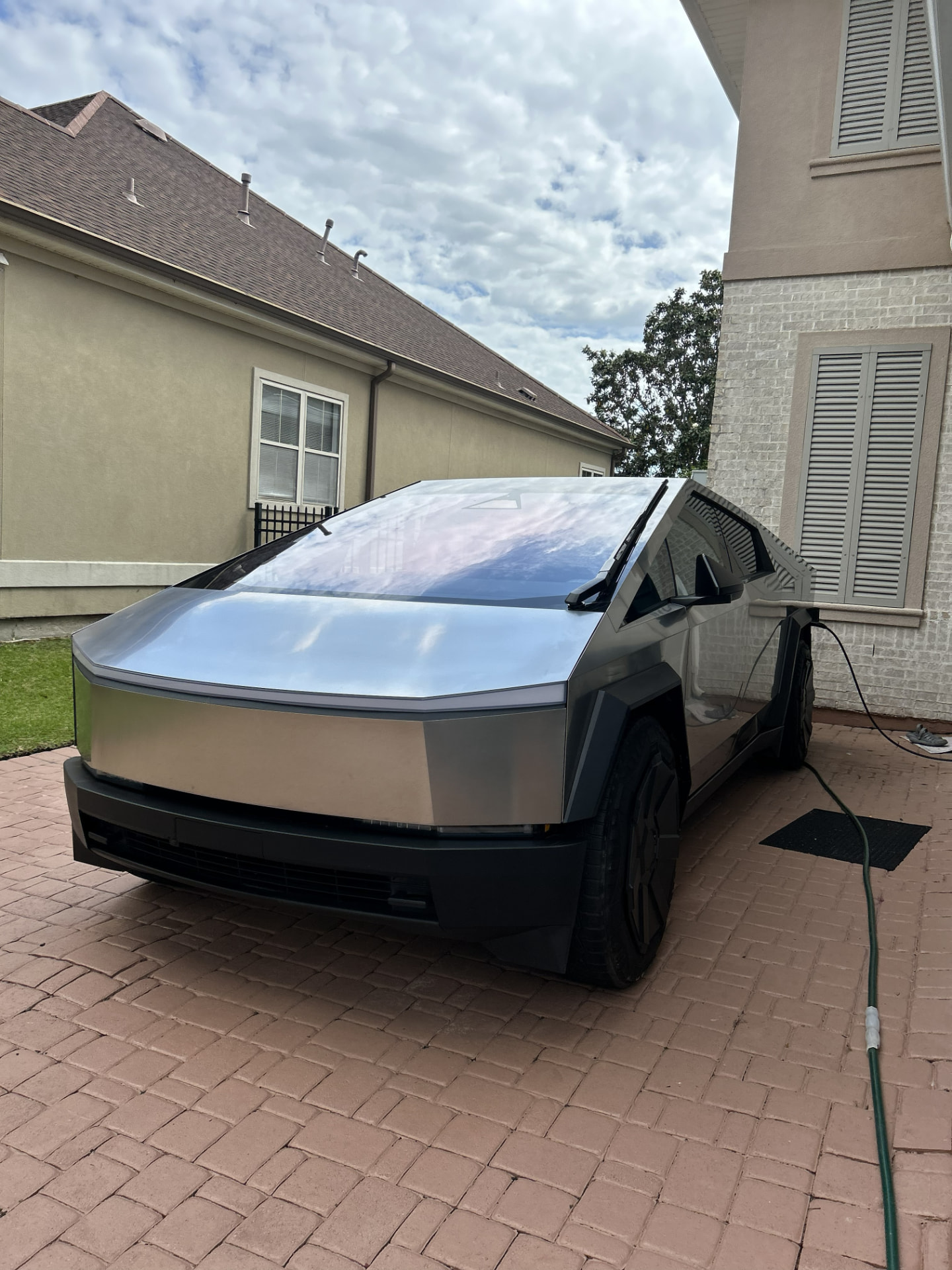 Tesla Cybertruck detailed on a brick driveway in Kenner, Louisiana with a spot-free stainless steel finish