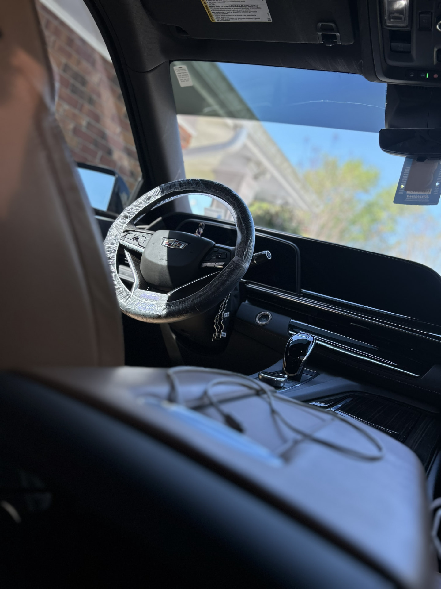 Cadillac Escalade interior with a protected steering wheel during a mobile interior detail near Kenner, Louisiana