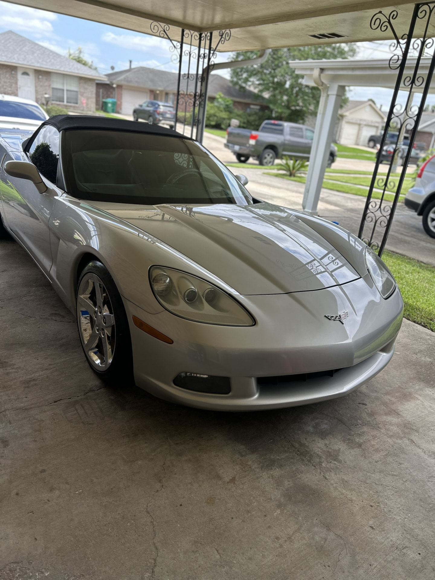 Silver Chevrolet Corvette convertible with a mirror-gloss finish after a two-stage paint correction in Kenner, Louisiana