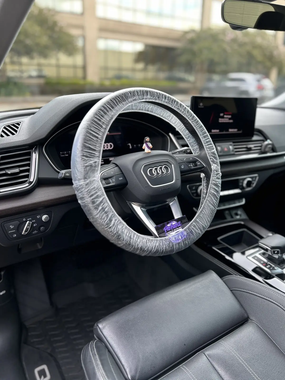 Protected Audi steering wheel and detailed leather interior after a mobile interior detail in Kenner, LA