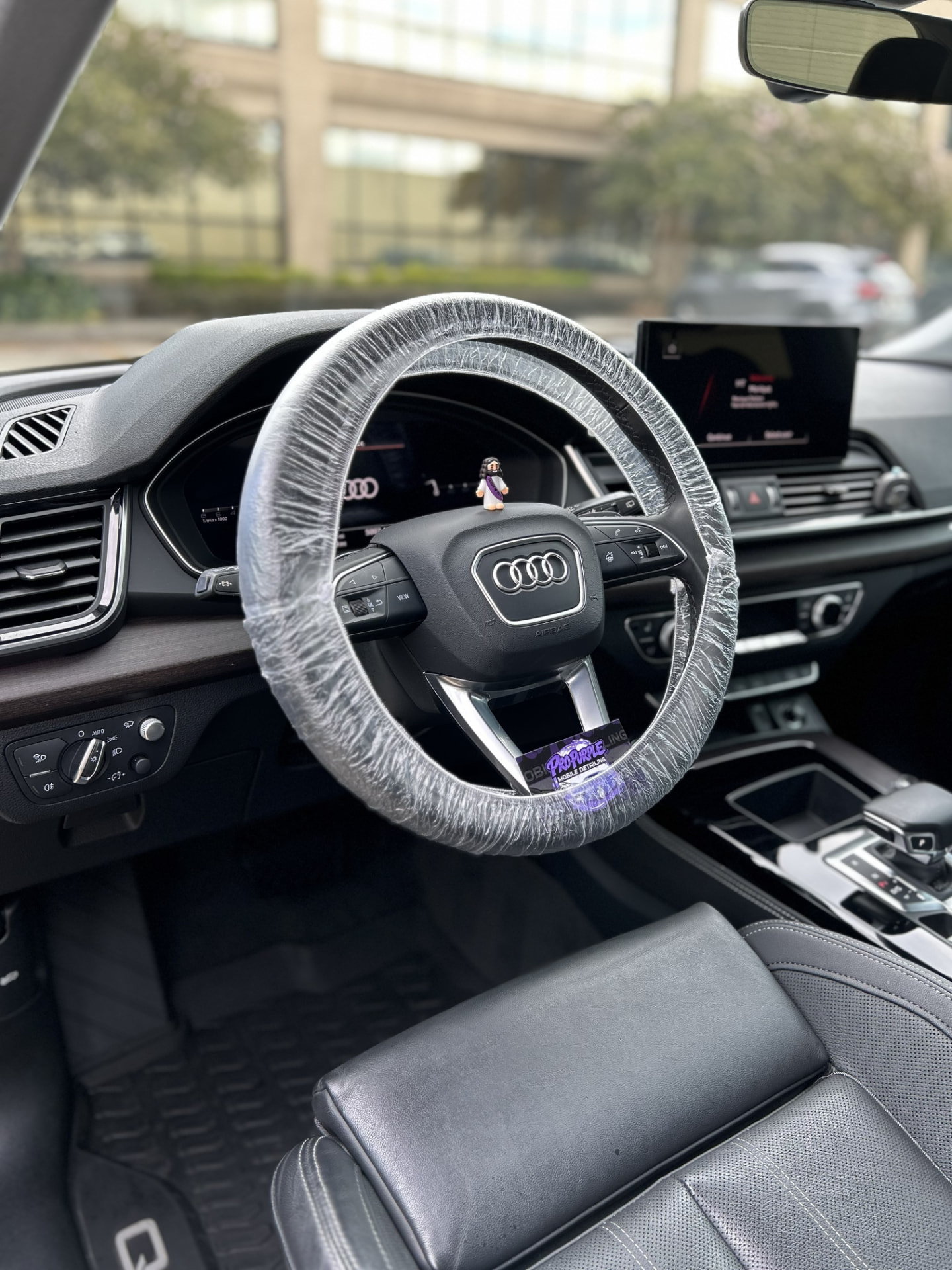 Protected Audi steering wheel and detailed leather interior after a mobile interior detail in Kenner, LA